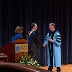 Former Provost Davis and President Emeritus Haas congratulate faculty member who is receiving an award